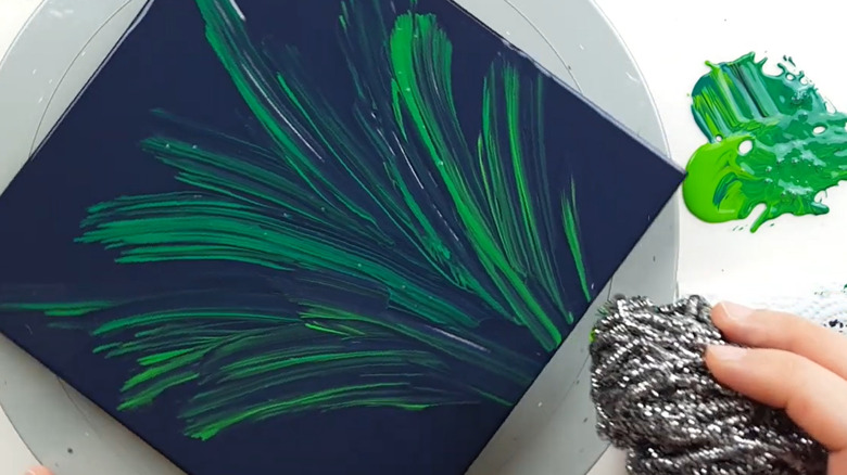screenshot of video showing painting using steel scour