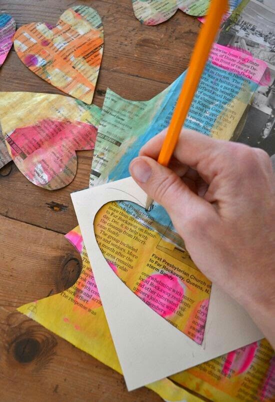 This may contain: someone is cutting out paper hearts with a pencil