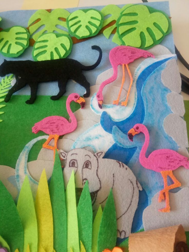 This may contain: an animal scene made out of felt and paper