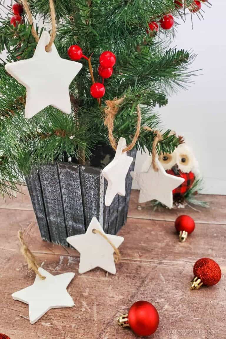 Examples of salt dough star ornaments on Christmas tree with red ornaments.
