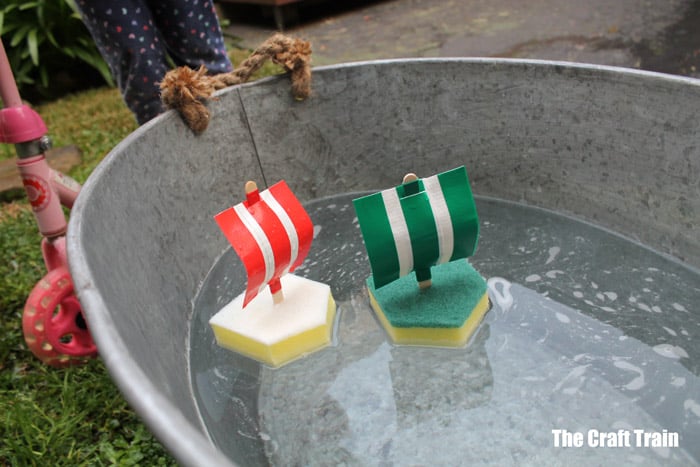 2 sponge and duct tape boats floating in a wash tub outside on the lawn from The Craft Train