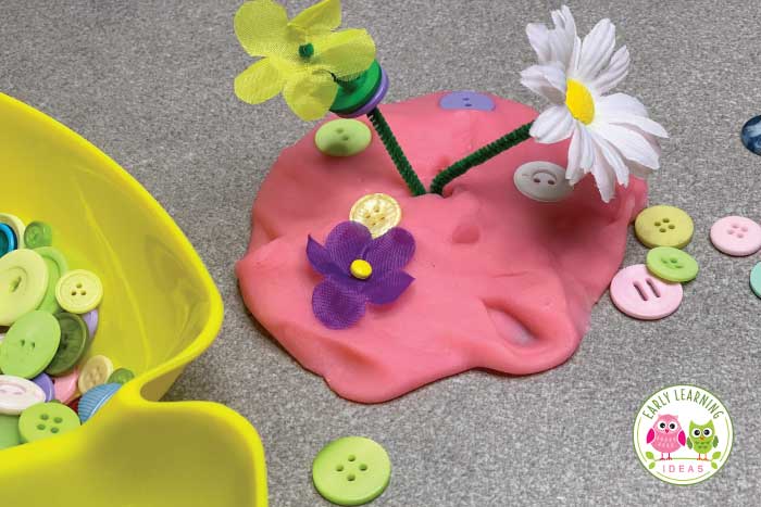 silk flowers and buttons with playdough