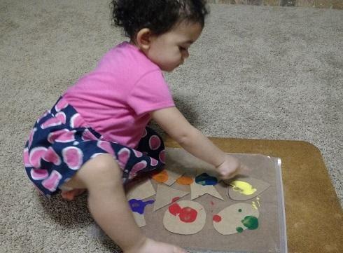 A baby playing with a toy

Description automatically generated with medium confidence