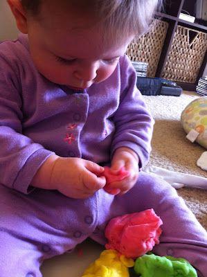 A baby playing with a toy

Description automatically generated with medium confidence