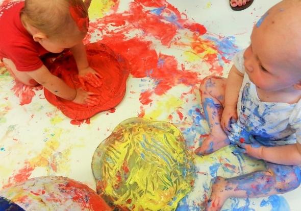 Babies playing with paint