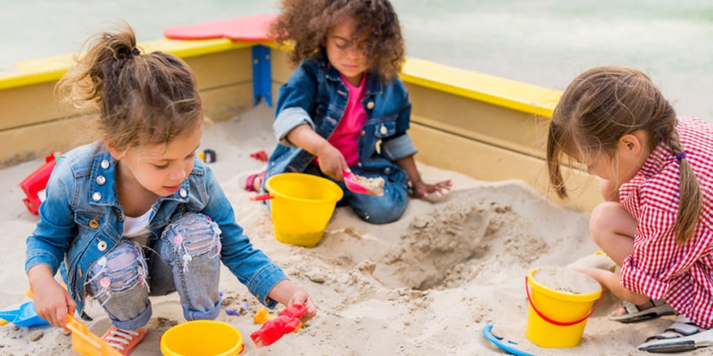 constructive play-3 girls playing in the sand box