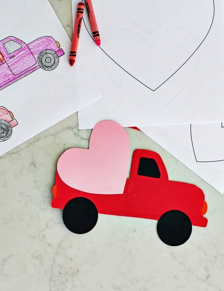 red truck made from paper with a heart glued onto it.