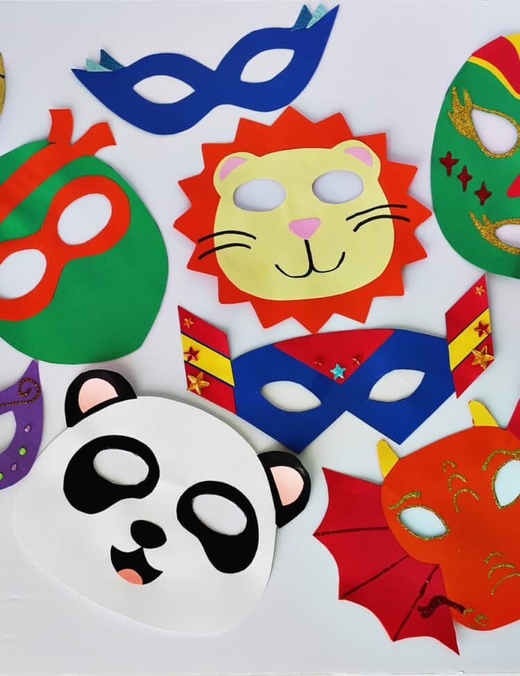 Cardstock in a variety of colors cut into mask shapes on a white background.