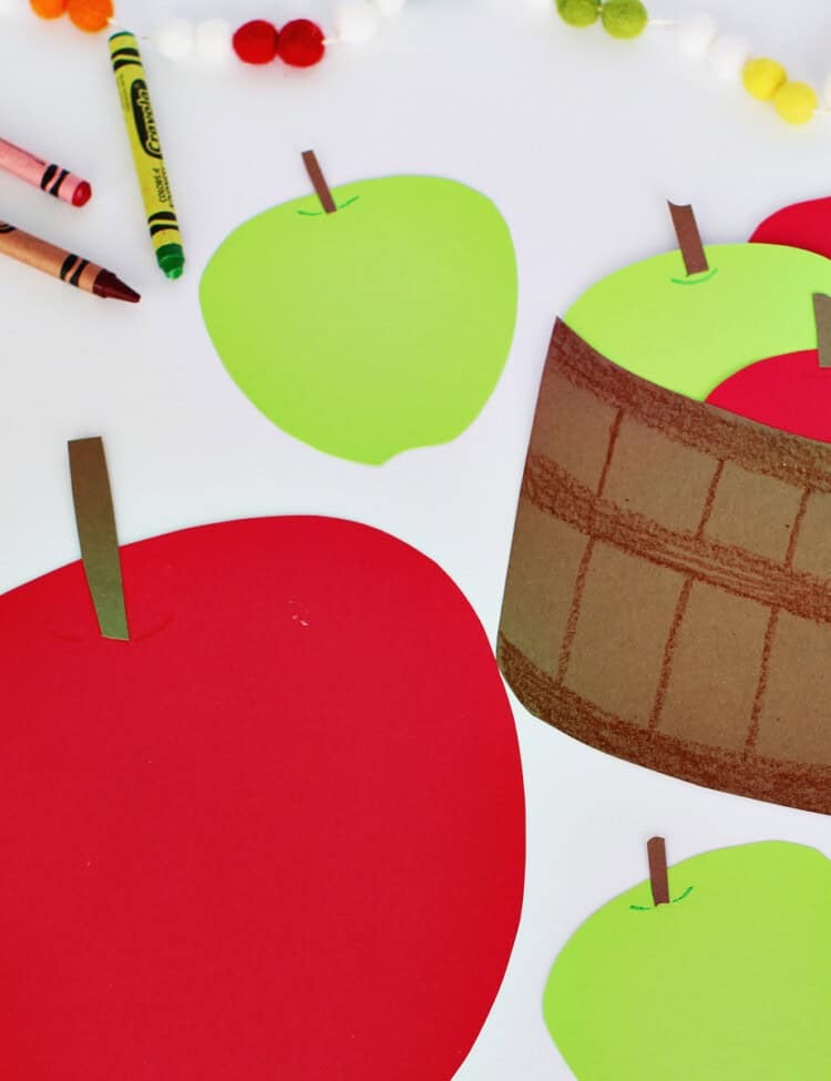 Red and grreen cardstock cut into apple shapes with brown stems. Also brown cardstock colored to look like a basket with apples coming out of it.