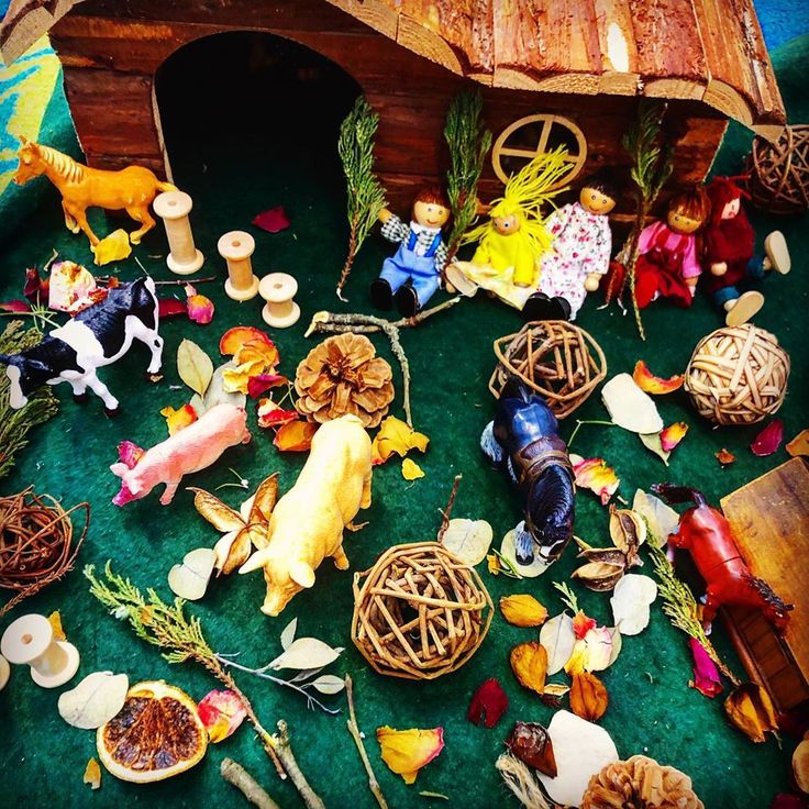 This may contain: a nativity scene with figurines, candles and other items on the ground