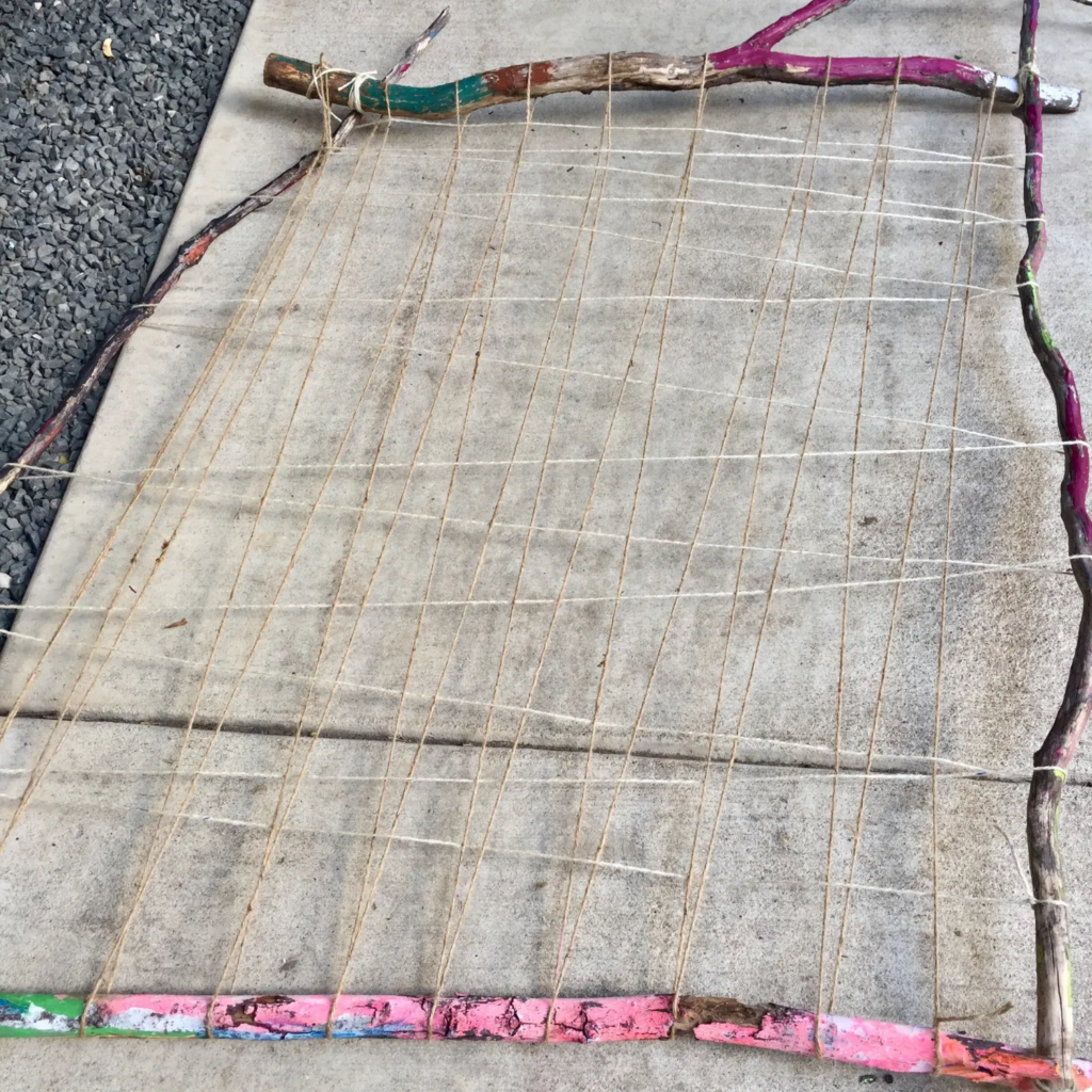 Yarn woven around natural branches