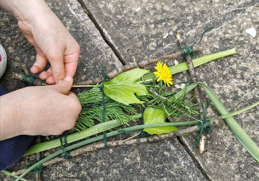 Child's hands weaving nature