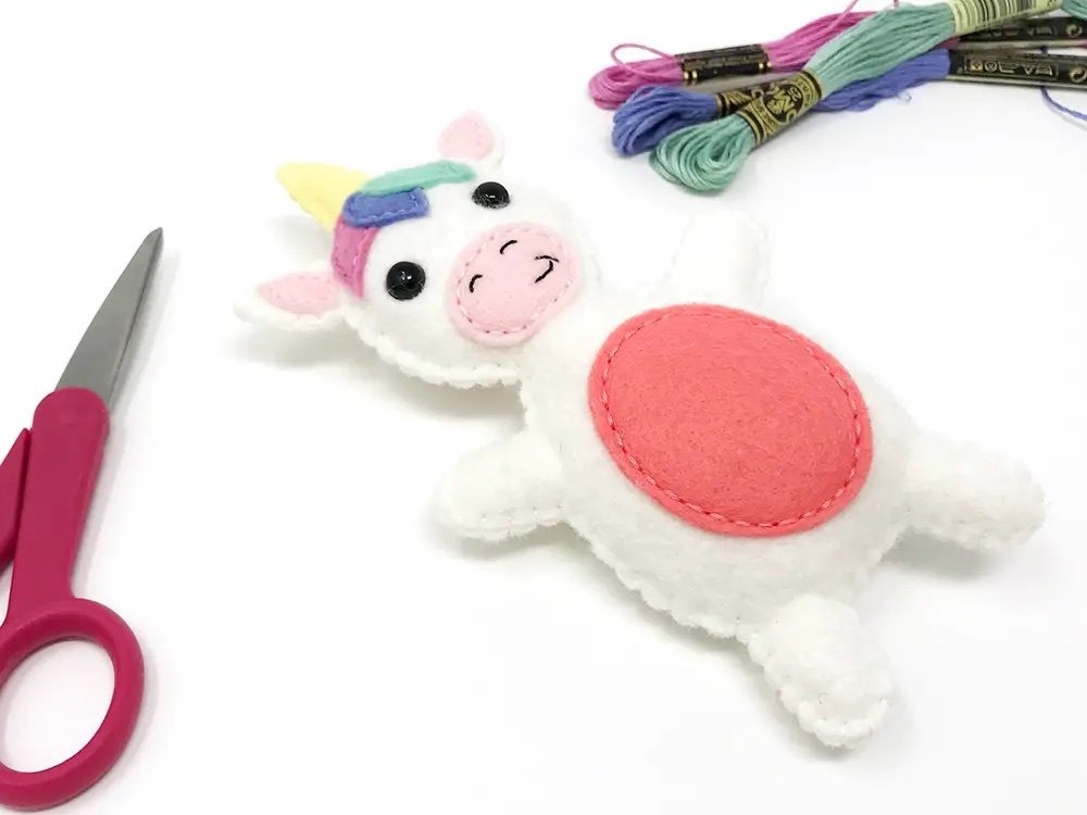 free felt animal pattern for white uniforn softie with colorful mane and redish belly
