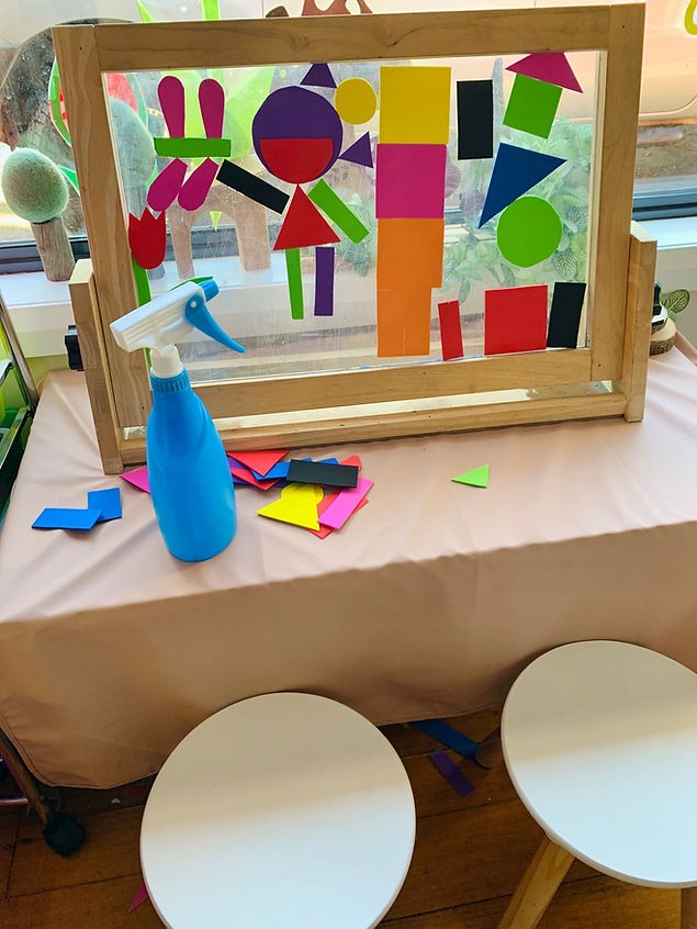 Kids art idea using foam shapes and a water spray bottle to create shape pictures.