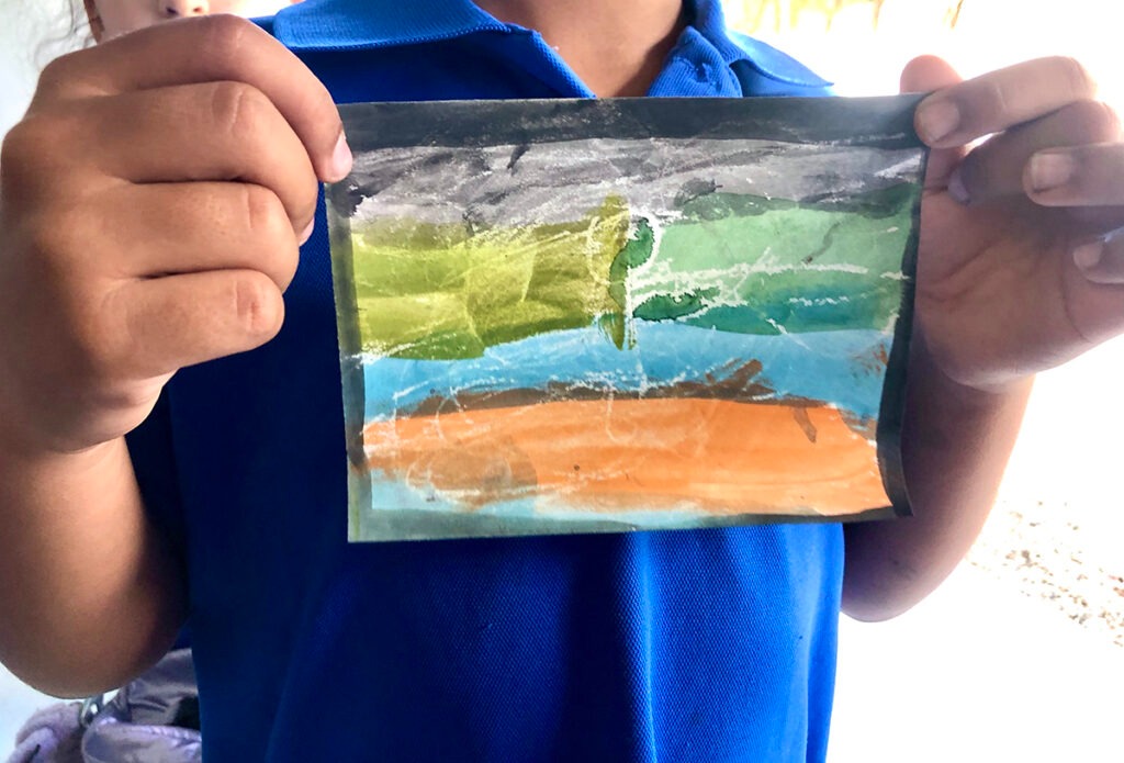 student holding mini art