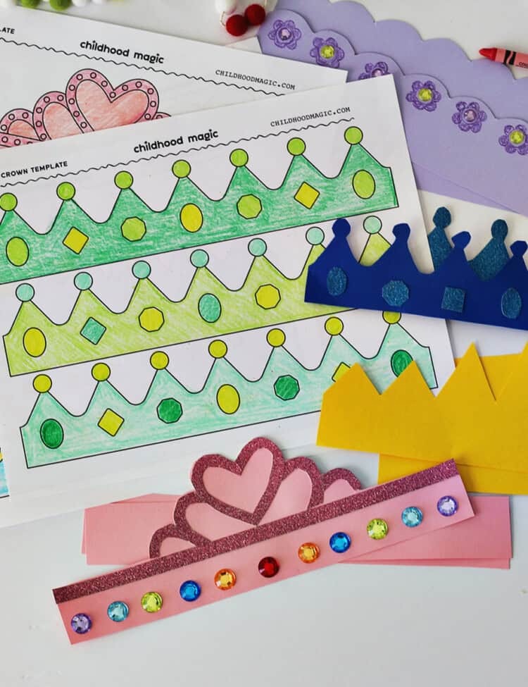 coloring sheet with crowns on it colored in with shades of green. Nex tto the coloring sheet are crowns cut out of cardstock paper.